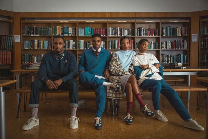 Four people recline on a bench in a library